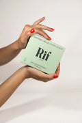 Hands holding a box of hemp fiber organic cotton biodegradable period pads against a plain background.