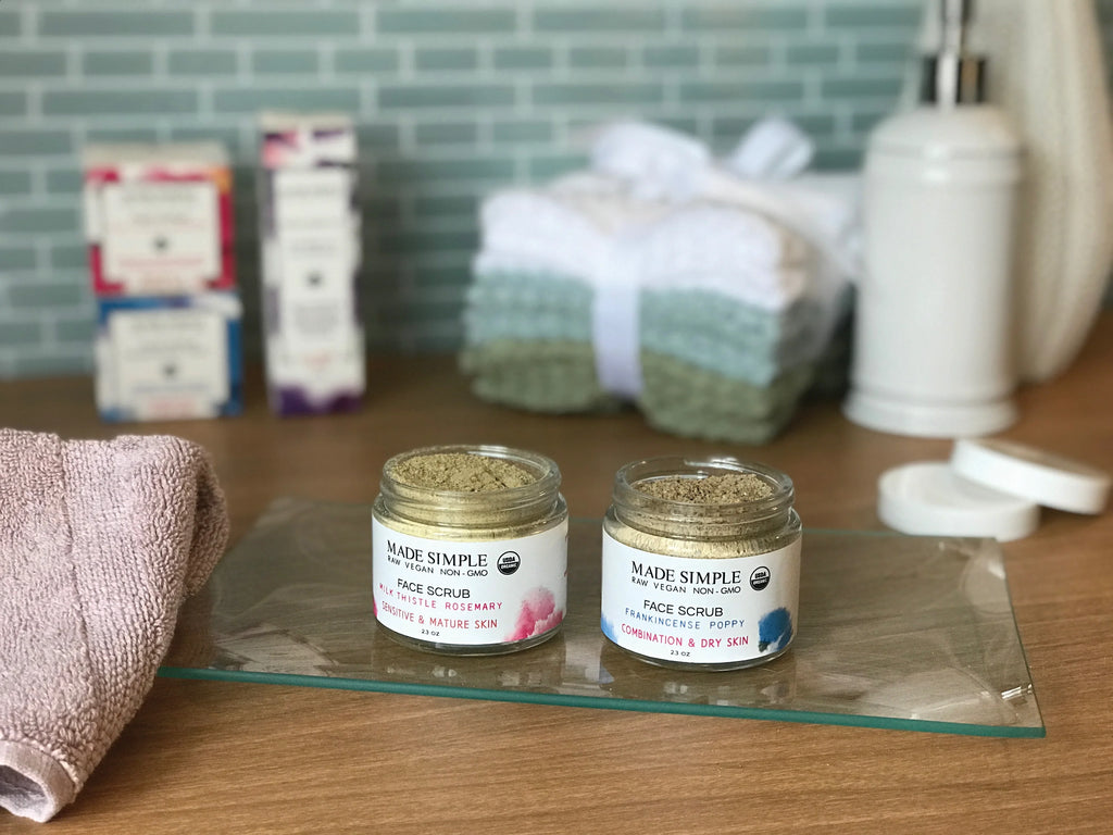 Two jars of organic face scrub for sensitive and dry skin on a bathroom counter