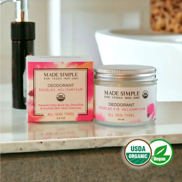 Organic vegan deodorant jar and box labeled Douglas Fir Helichrysum on bathroom counter