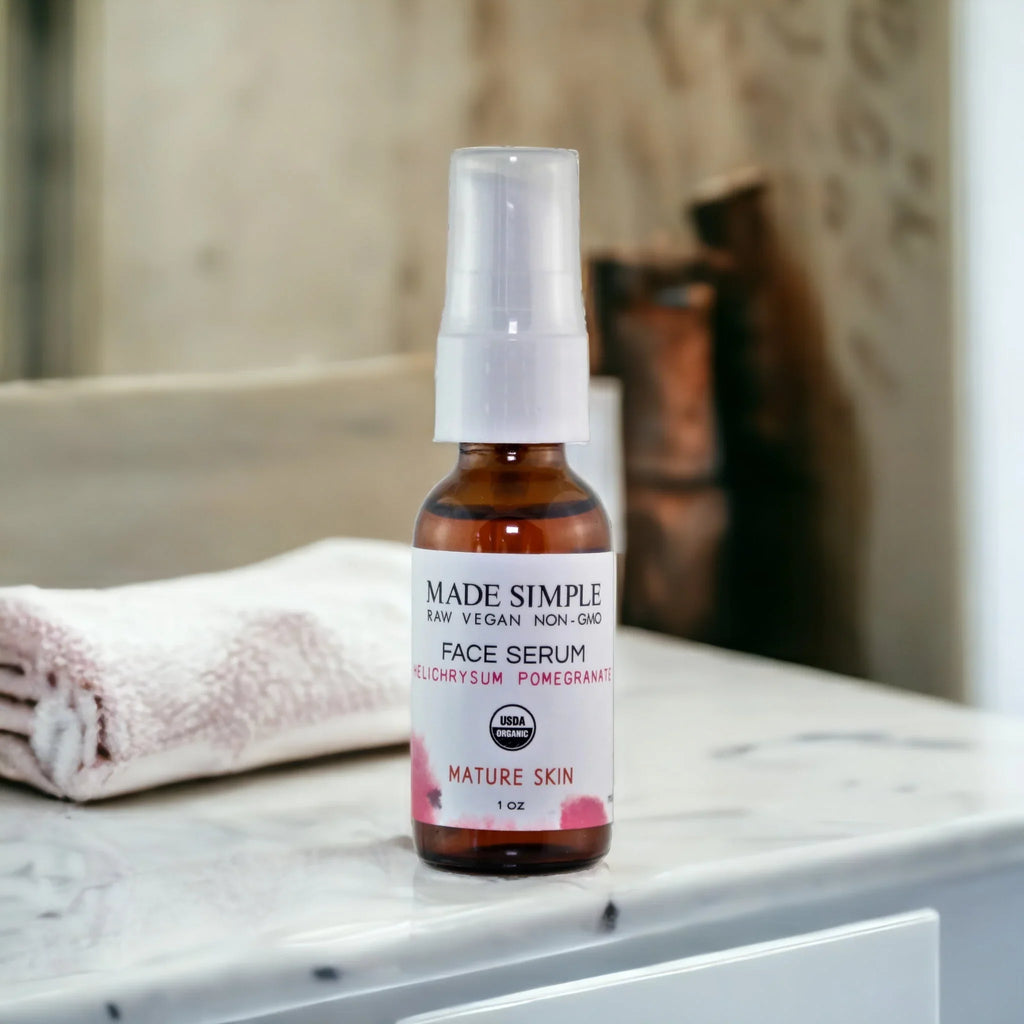 Organic vegan face serum for mature skin on marble bathroom counter