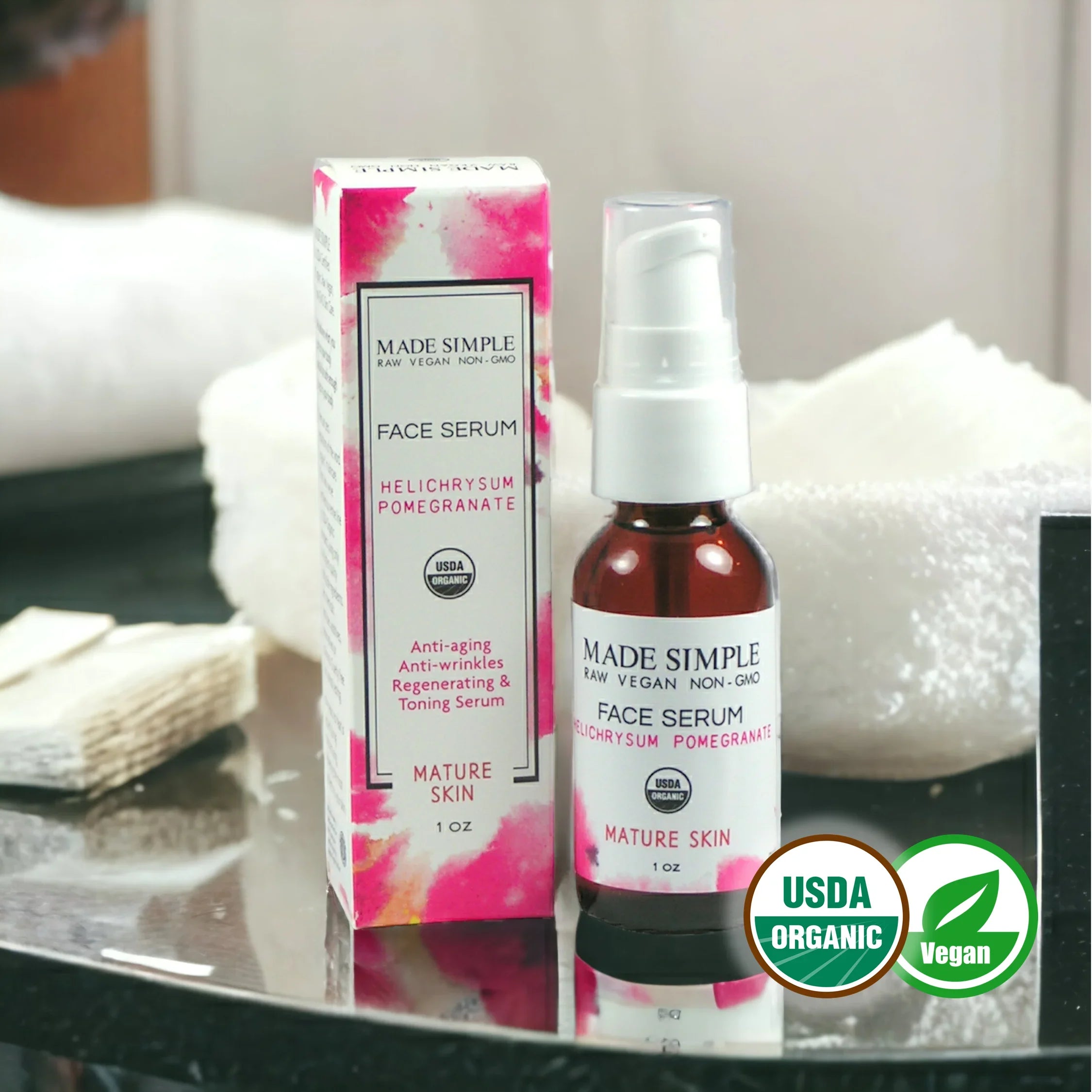 Organic vegan face serum for mature skin with box, anti-aging, USDA certified, on bathroom counter.